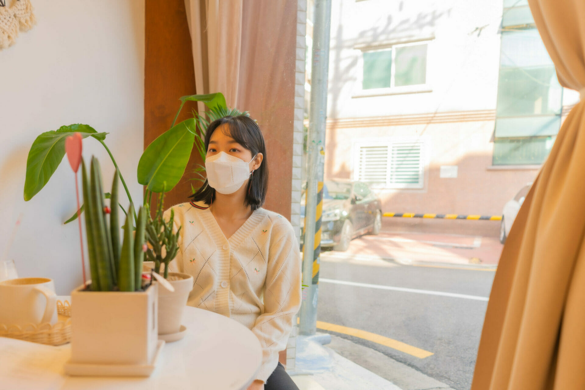 Top Korean Fashion Trends In 2023 51 Korean girl in cafe wearing white-knit cardigan